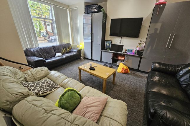 A Cozy, Well-Lit Living Room Featuring Comfortable...