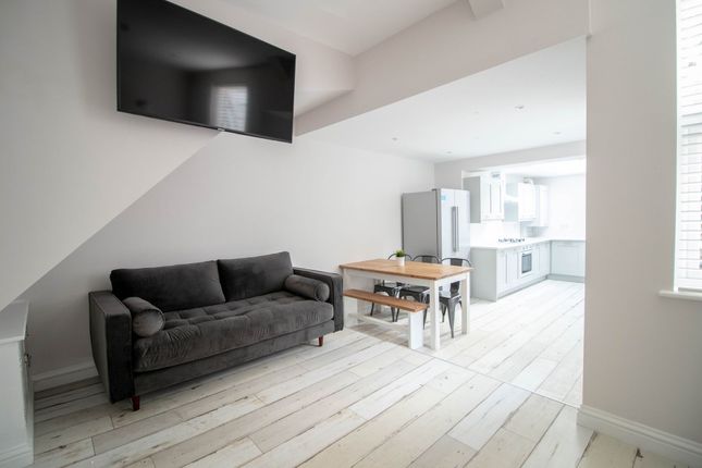 A Modern, Spacious Living Room With A Large Flat-S...