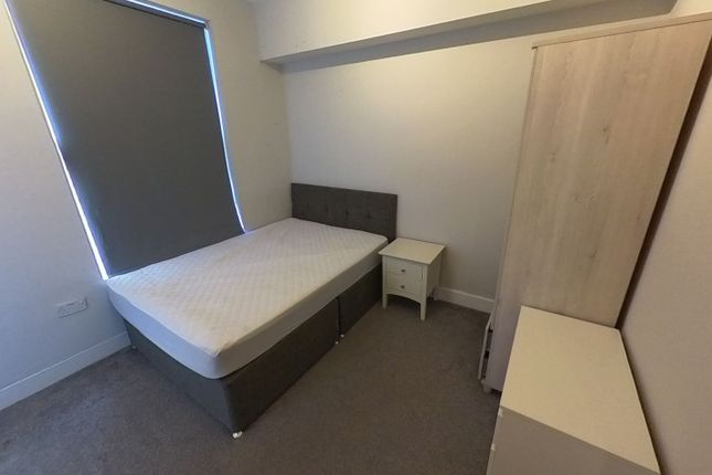 A Small, Clean Bathroom With Basic Fixtures, Featu...