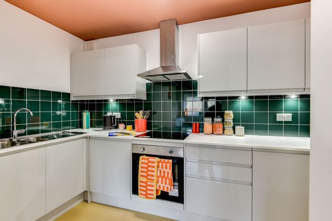 This Modern Kitchen Features Sleek Cabinetry, Ampl...