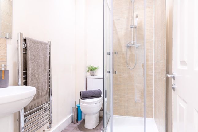 A Modern Bathroom Featuring A Sleek Glass Shower, ...