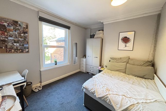 A Well-Maintained Bedroom Featuring A Comfortable ...