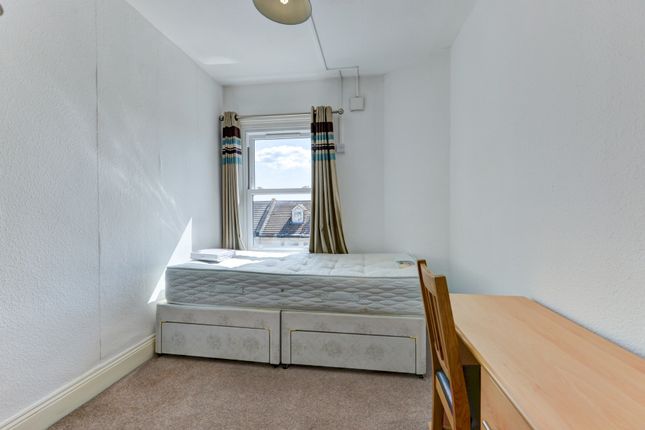 A Tidy Single Bedroom With A Well-Made Bed Positio...