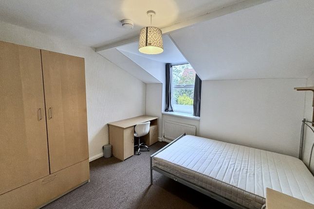 A Bright And Tidy Double Bedroom Featuring A Desk ...