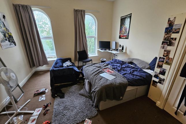 A Cozy Bedroom Featuring A Large Bed, Natural Ligh...