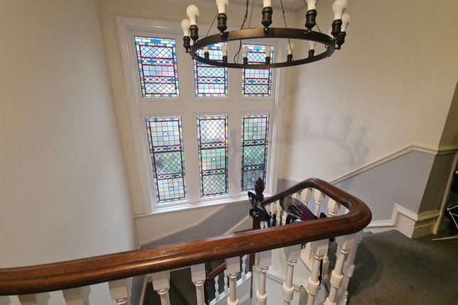 A Charming Staircase With A Classic Wooden Handrai...