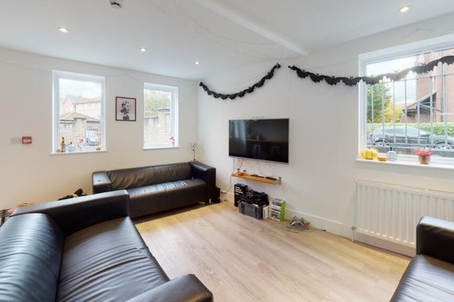 Bright And Inviting Living Room Featuring Large Wi...