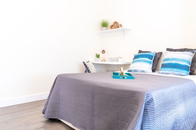 This Inviting Double Bedroom Features A Cozy Atmos...