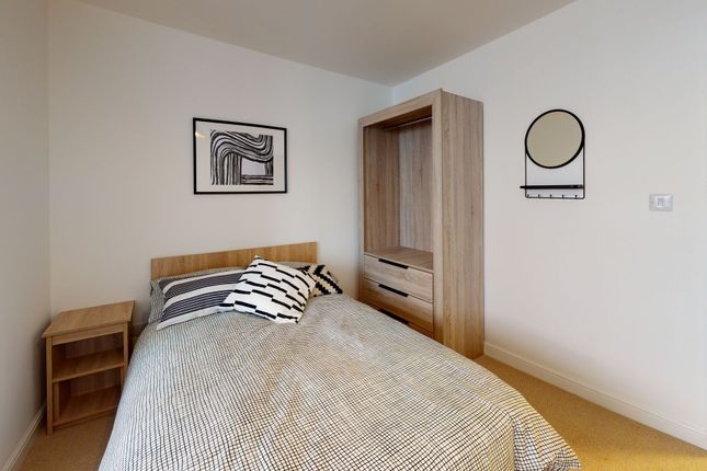 A Cozy, Well-Maintained Bedroom Featuring Stylish ...