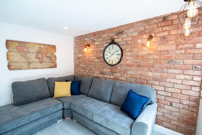 A Stylish Living Room Featuring A Spacious Grey So...