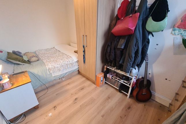 A Cozy Single Bedroom Featuring A Neatly Made Bed ...