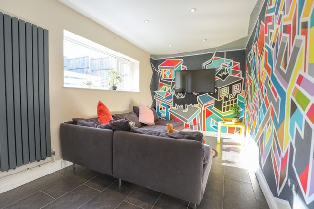 A Vibrant And Modern Living Room Featuring A Color...