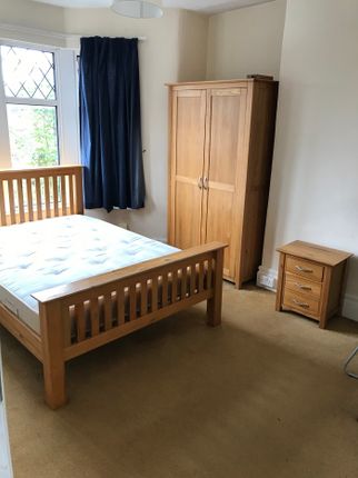 Spacious Double Bedroom Featuring A Cozy Wooden Be...