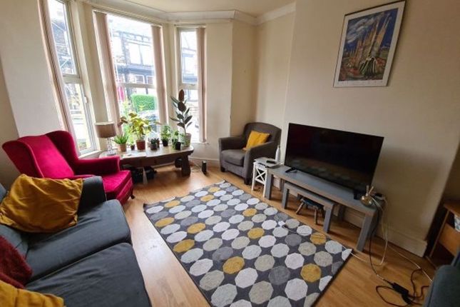 A Bright And Inviting Living Room Featuring A Larg...