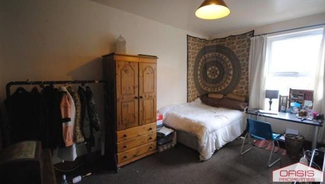 Bright And Cozy Bedroom Featuring A Neatly Made Be...