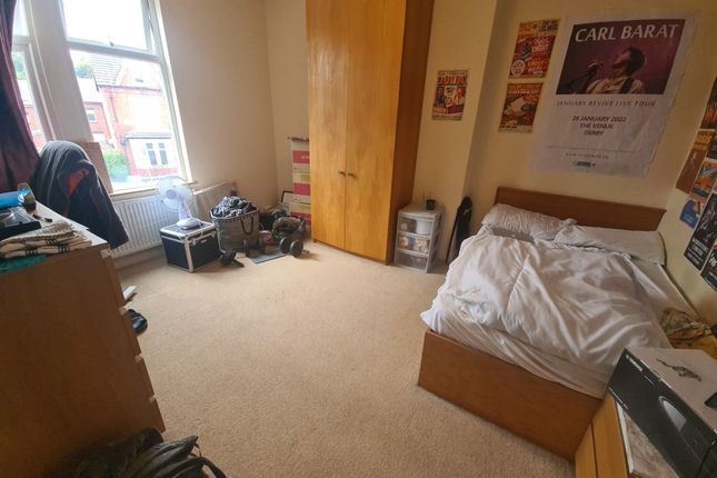 A Cozy Single Bedroom Featuring A Large Window Tha...