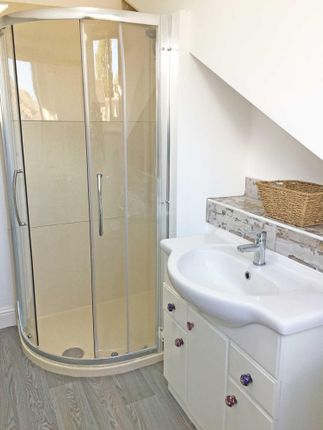 Bright, Well-Kept Bathroom With A Curved Glass Cor...