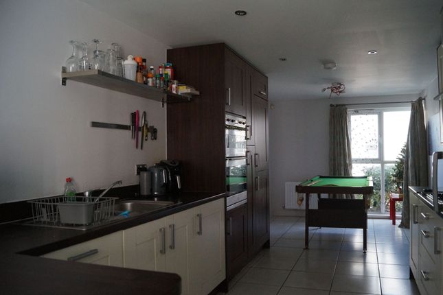 A Modern Kitchen With Dark Wood Cabinetry And Ligh...