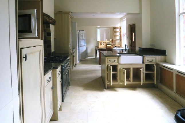 A Spacious Kitchen With A Classic Design Featuring...