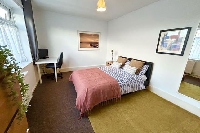 A Cozy Double Bedroom Featuring A Comfortable Bed,...