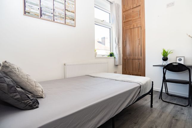 A Bright, Minimalist Bedroom Featuring A Spacious ...