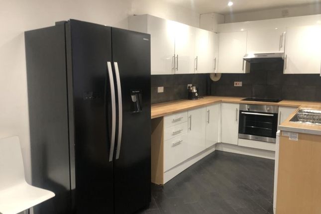 Modern Kitchen Featuring Sleek Black And White Cab...