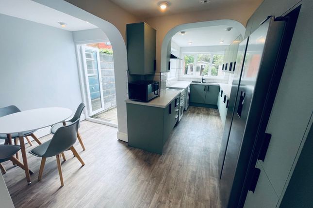 Bright, Modern Galley Kitchen With A Stylish Dinin...