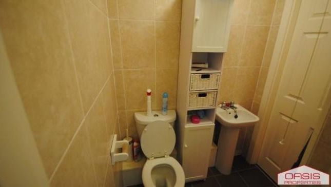 A Clean And Functional Bathroom Featuring A Toilet...
