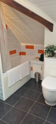 A Charming Bathroom Suite With A Unique Slanted ce...