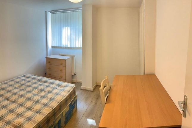 A Neat And Tidy Single Bedroom Featuring A Comfort...