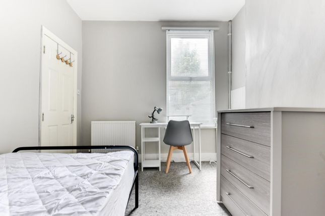 A Bright And Airy Bedroom Featuring A Tidy Space W...