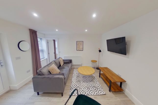 A Spacious And Modern Living Room Featuring Stylis...