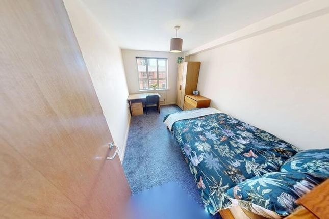 A Cozy Single Bedroom Featuring A Neatly Made Bed ...