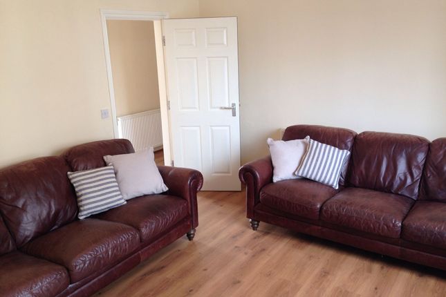 A Cozy Living Room Featuring Two Comfortable Brown...