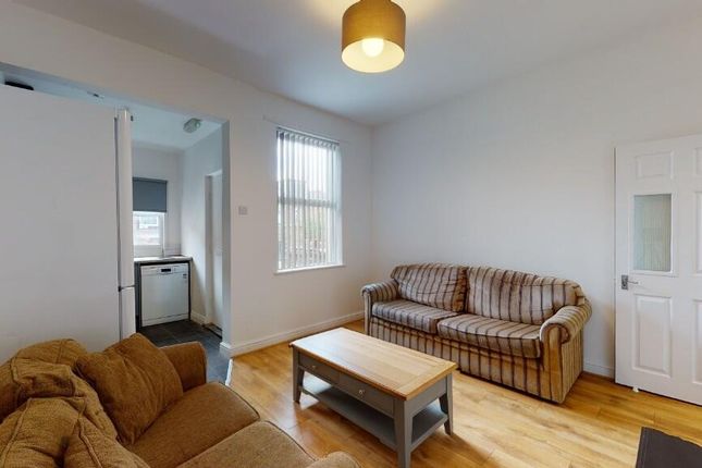 A Bright And Welcoming Living Room Featuring Comfo...