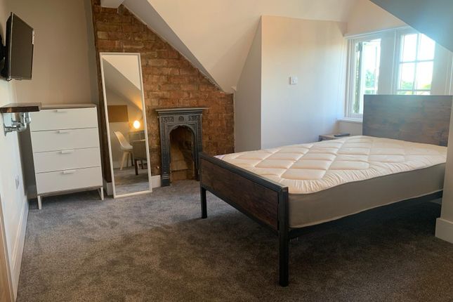 Spacious And Well-Lit Bedroom Featuring A Sturdy d...