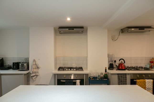 Modern Kitchen Area With Appliances And Bright Lig...