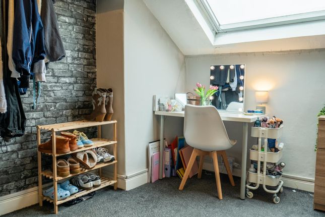 A Well-Lit Bedroom Featuring A White Desk With A d...