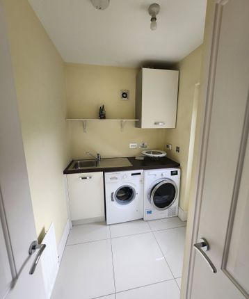 Bright And Tidy Laundry Room Featuring Modern Wash...