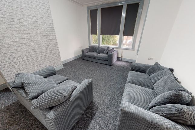 A Spacious And Modern Living Room With Comfortable...