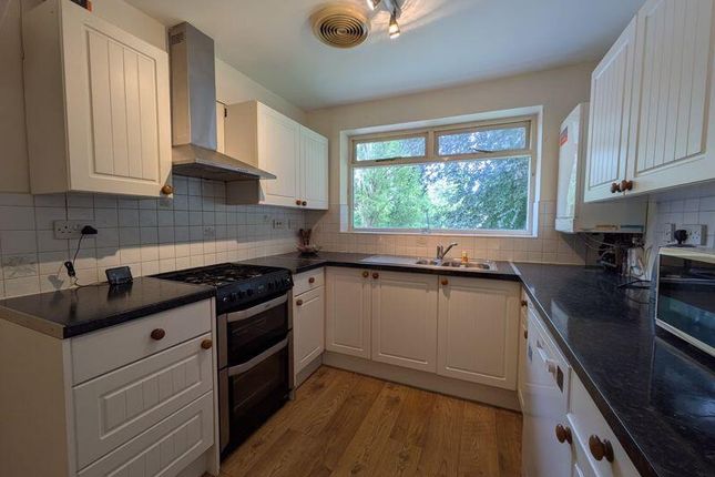 A Bright And Modern Kitchen Featuring Cream Cabine...