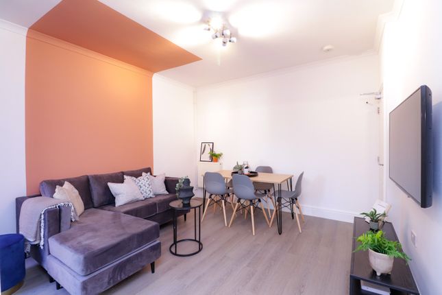 A Bright And Inviting Large Modern Living Room Wit...