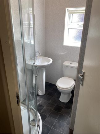 A Compact, Well-Maintained Bathroom Featuring A Sh...
