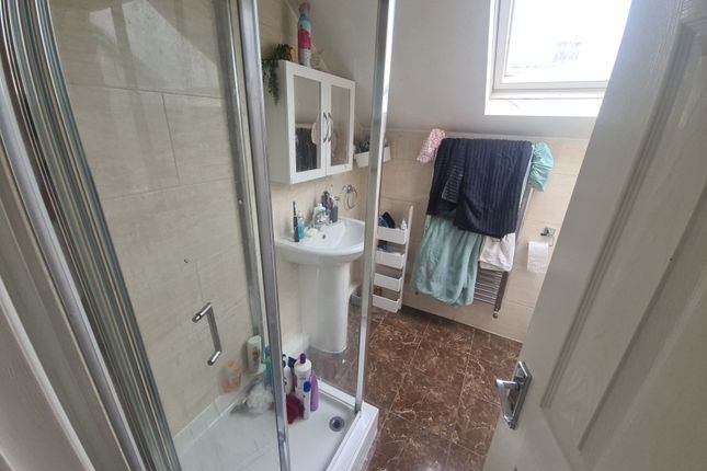 A Clean And Modern Bathroom Featuring A Glass Show...