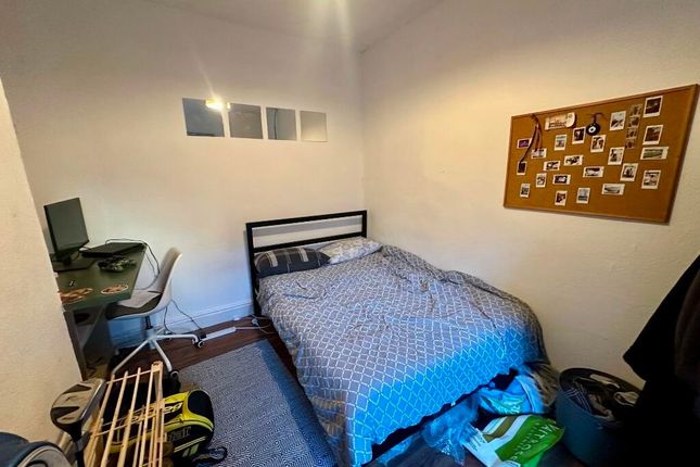 Cozy Single Bedroom Featuring A Comfortable Bed, A...