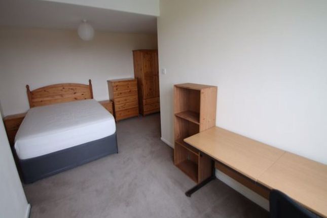 A Tidy And Functional Bedroom Featuring A Comforta...