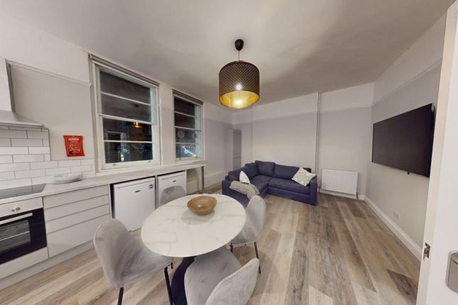 A Modern Kitchenette With A Cozy Dining Area, Perf...