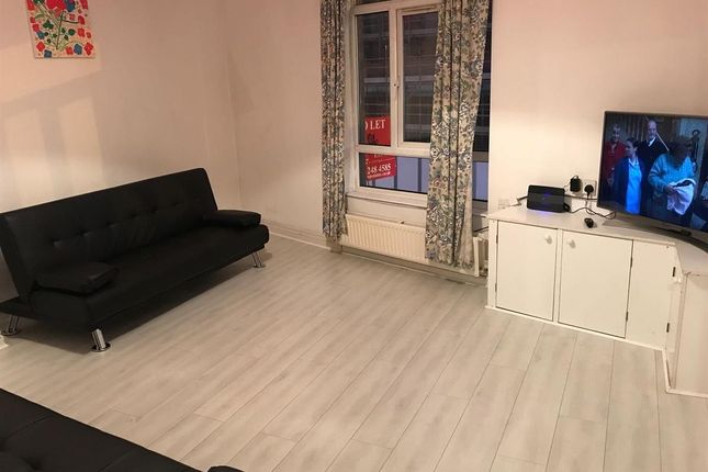 A Modern, Well-Lit Living Room Featuring A Large B...