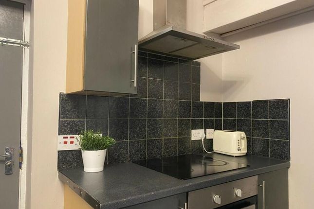 A Clean And Modern Kitchenette With Stylish Black ...