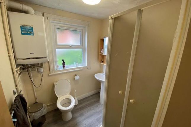 A Compact And Functional Bathroom Featuring A Toil...